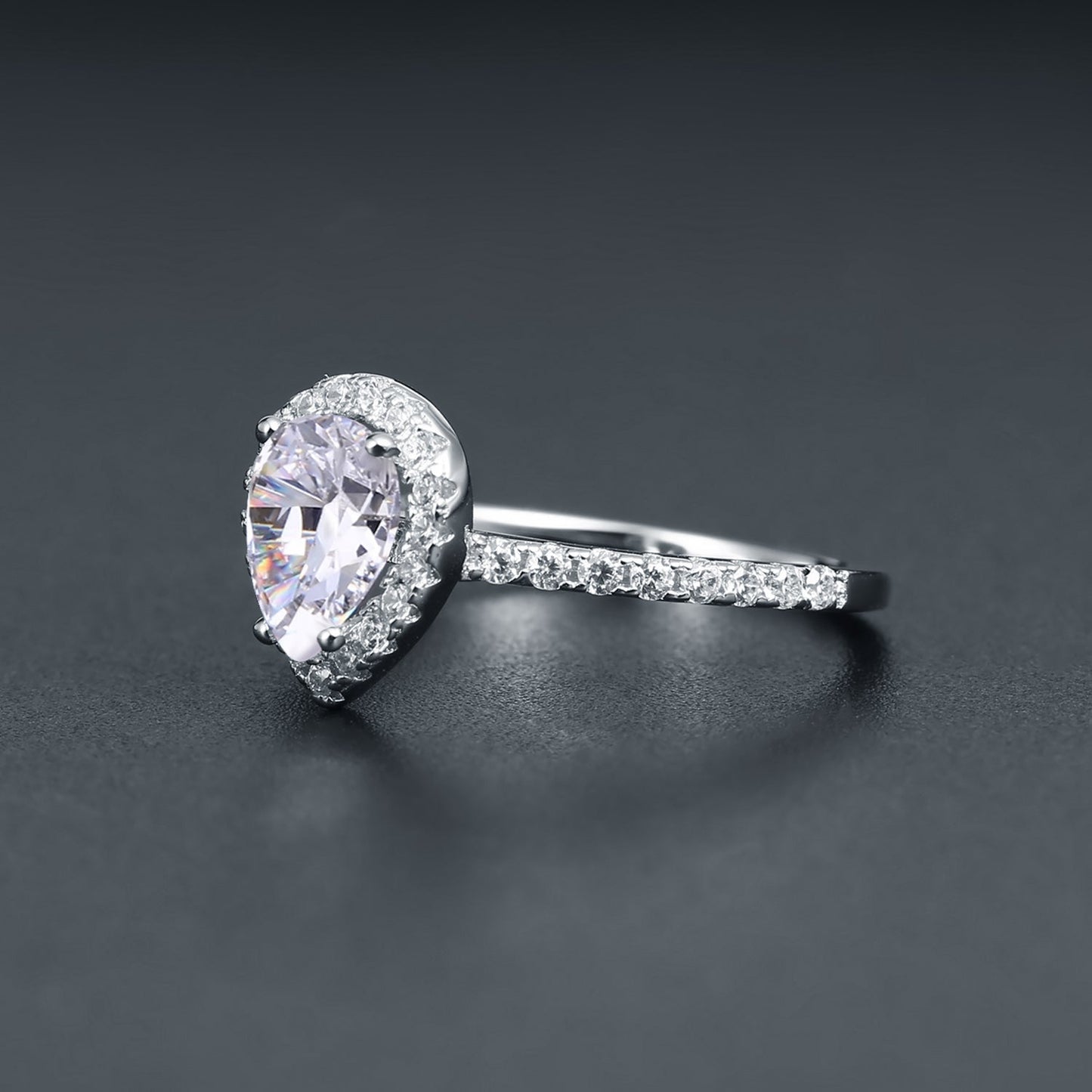 A classic and sophisticated design showcasing a 1.25ct pear-shaped moissanite with a sparkling halo.