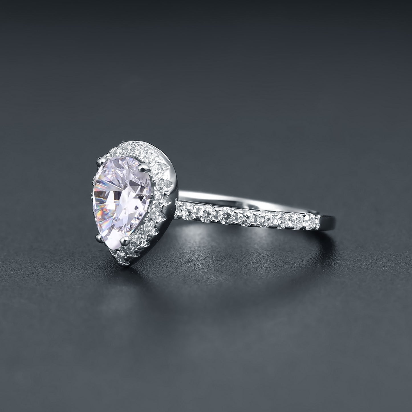 A beautiful engagement ring featuring a 1.25ct pear-shaped moissanite as the focal point, enhanced by a halo setting, crafted in sterling silver.