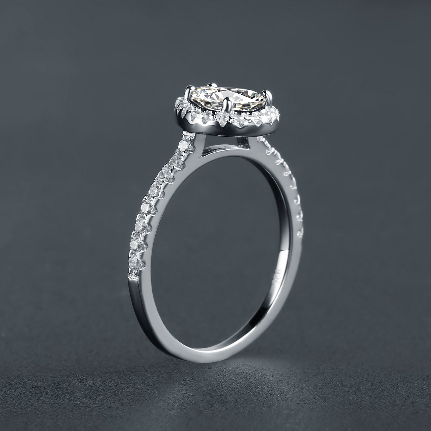This sterling silver engagement ring features a stunning 1.25ct pear-shaped moissanite encircled by a halo, offering a classic and sophisticated look.