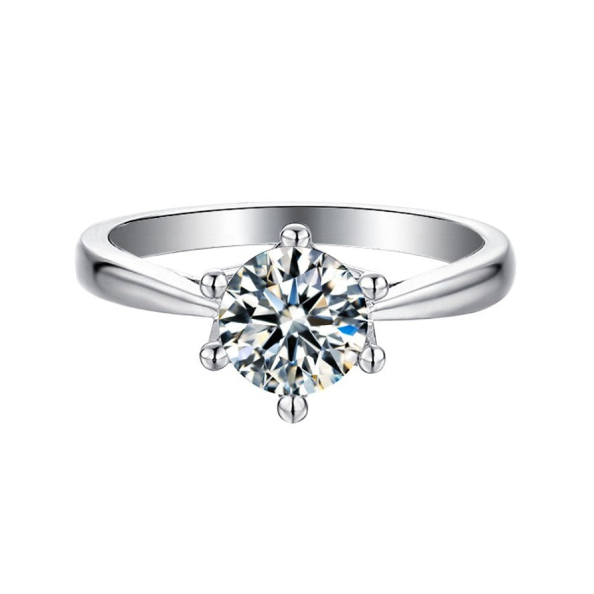 Showcasing a brilliant 1.00ct moissanite in a 6-claw setting with intricate floral basket detailing, all in 9ct white gold.
