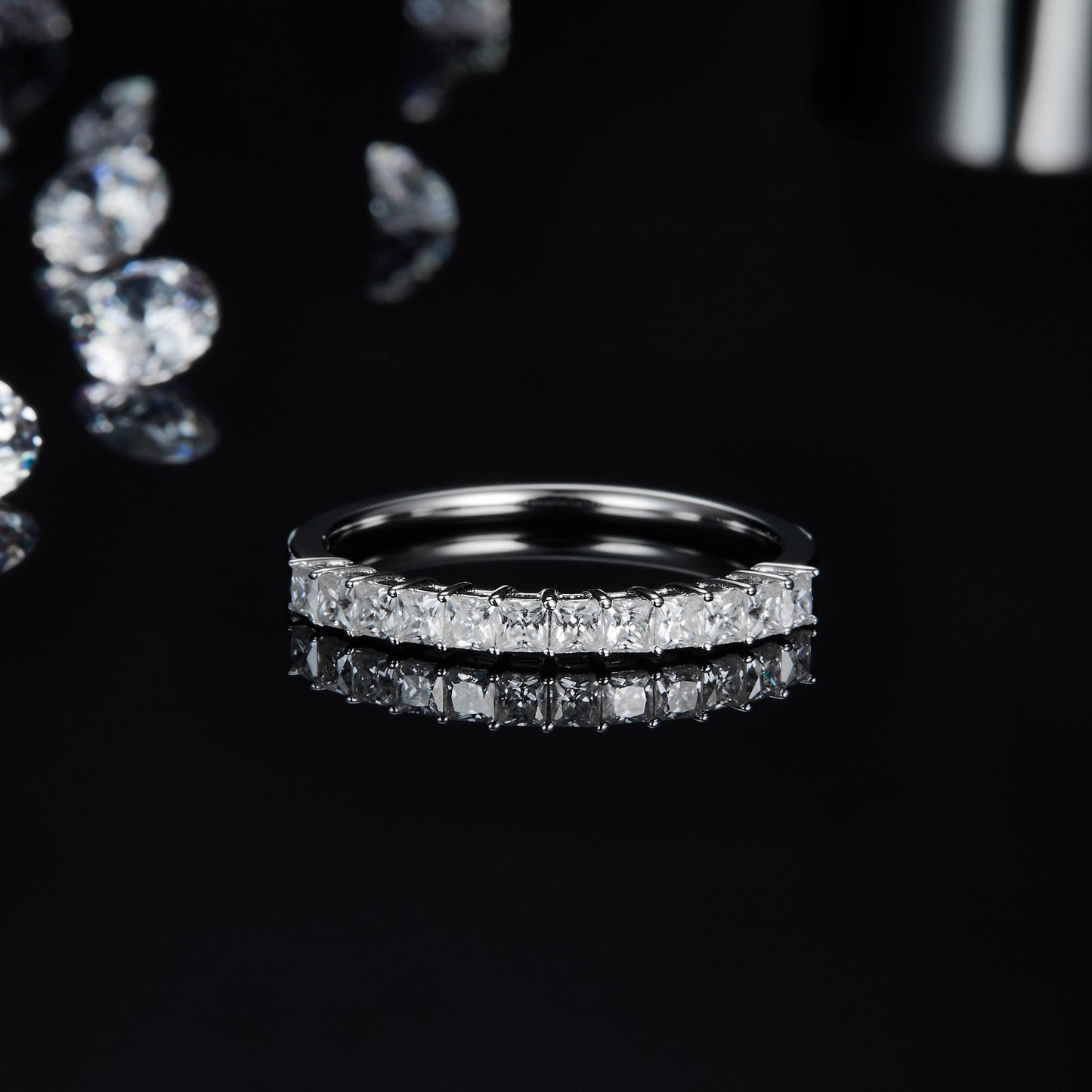 This half eternity wedding band set features square cut moissanites set in a sleek and polished sterling silver setting.