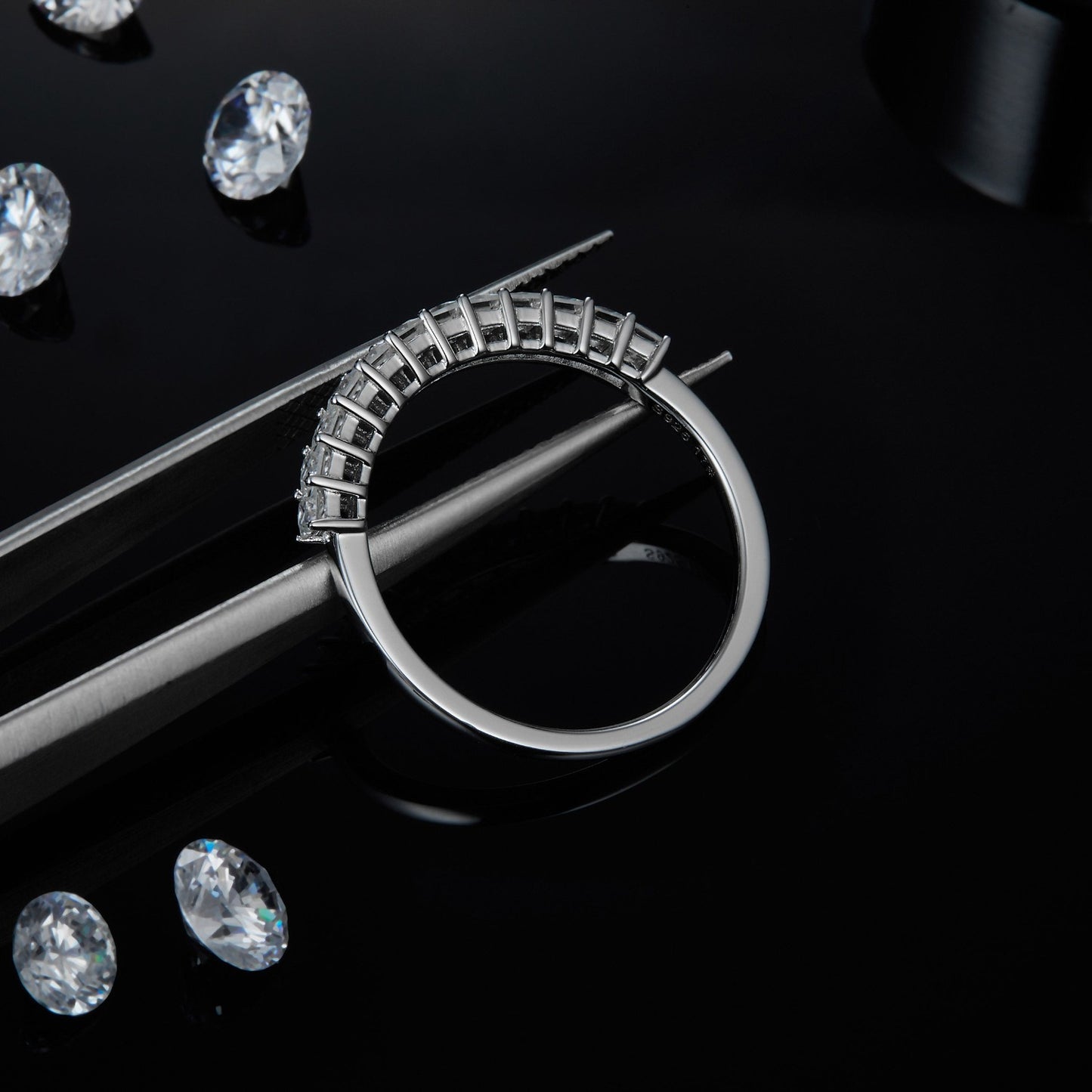 A shimmering set of wedding bands in sterling silver, adorned with square brilliant moissanites in a classic half eternity style.