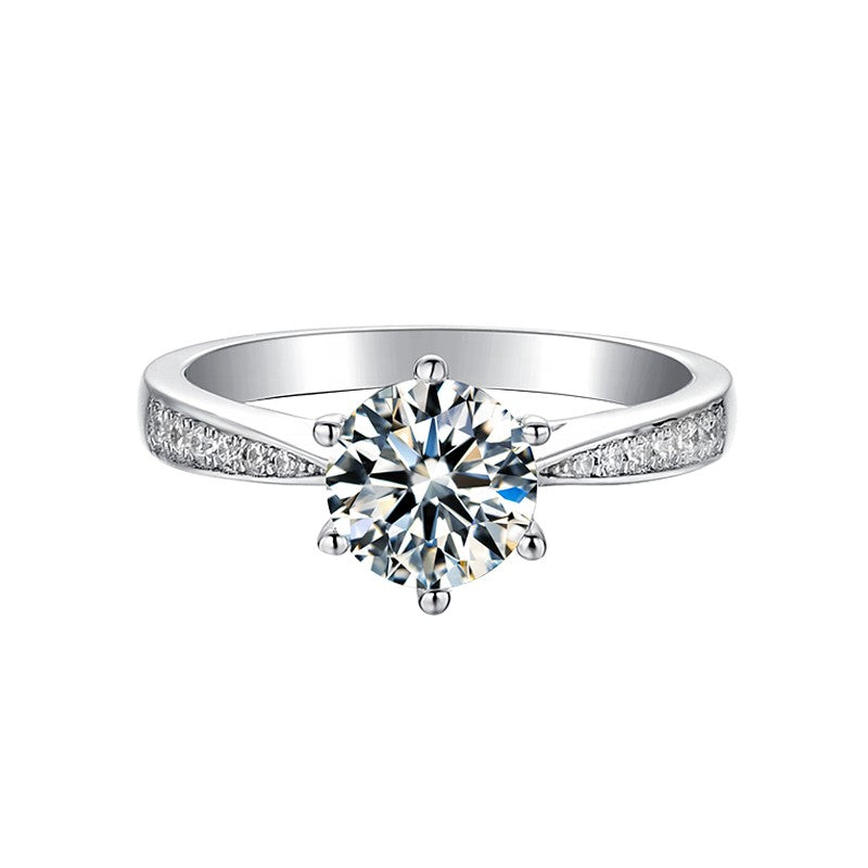 This 9ct white gold engagement ring features a brilliant 1.00ct moissanite and a dazzling tapered pave band.