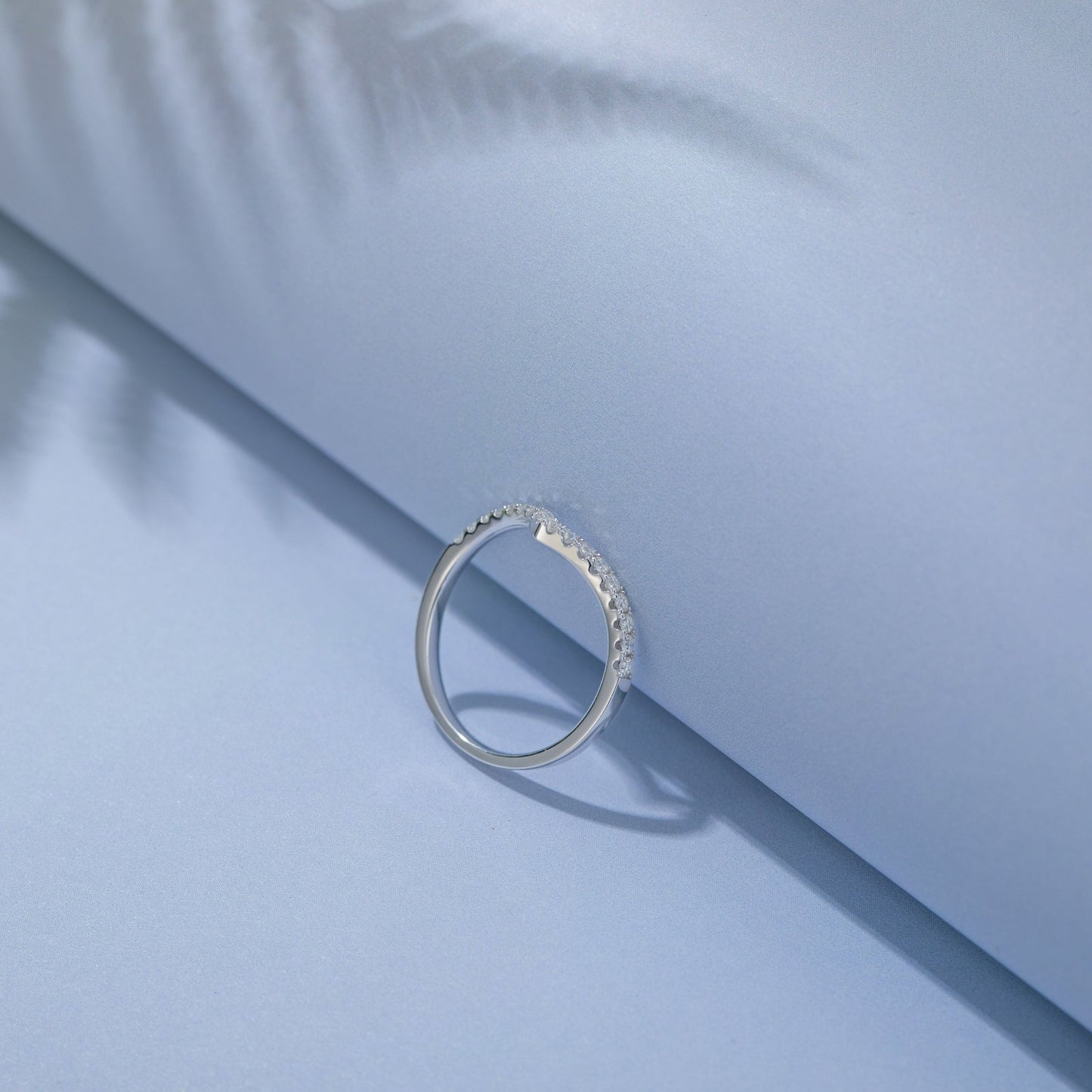 A beautifully crafted set of wedding bands featuring a subtle wishbone design and sparkling moissanites, perfect for couples seeking a unique and elegant symbol of their commitment.