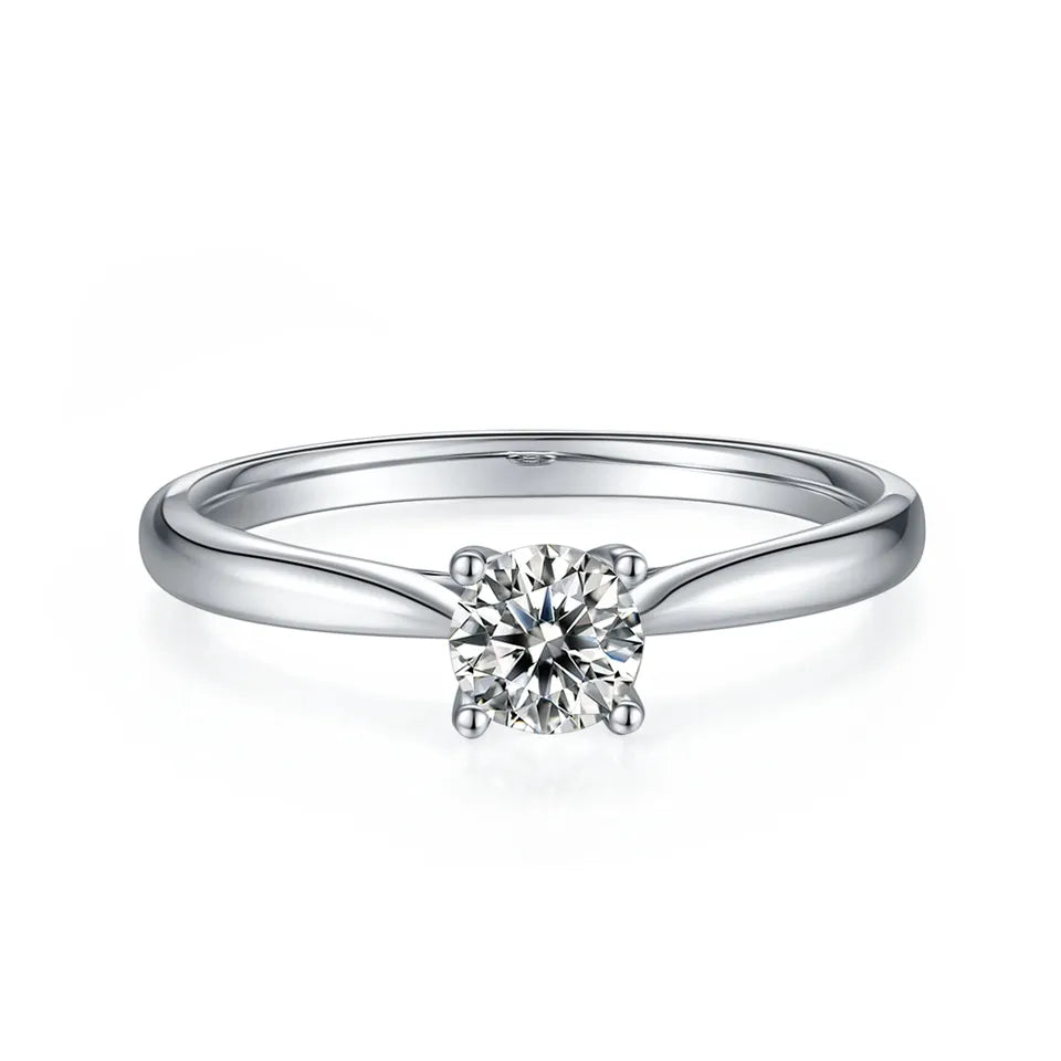 Elegant and timeless 4-prong solitaire engagement ring featuring a sparkling moissanite.
