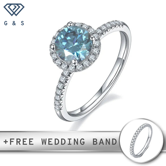 A 1.00ct round blue moissanite sparkles within a classic halo setting, creating a vibrant and elegant engagement ring.