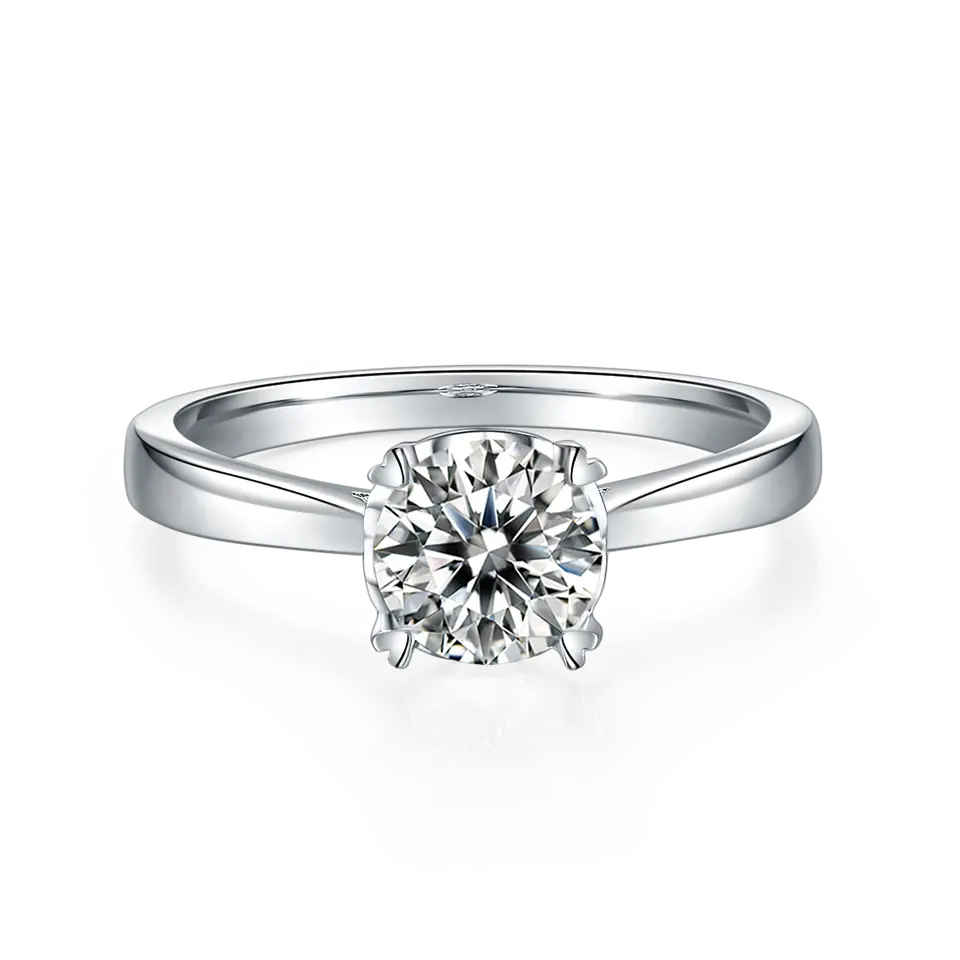 This elegant solitaire ring showcases a sparkling 1.00ct moissanite set with delicate heart-shaped prongs on a polished sterling silver band.