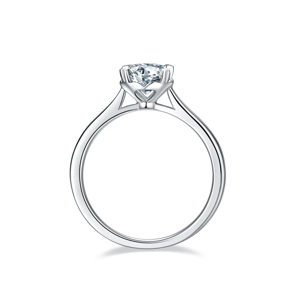 A beautiful sterling silver engagement ring highlighting a dazzling 1.00ct moissanite secured by four romantic heart-shaped claws.