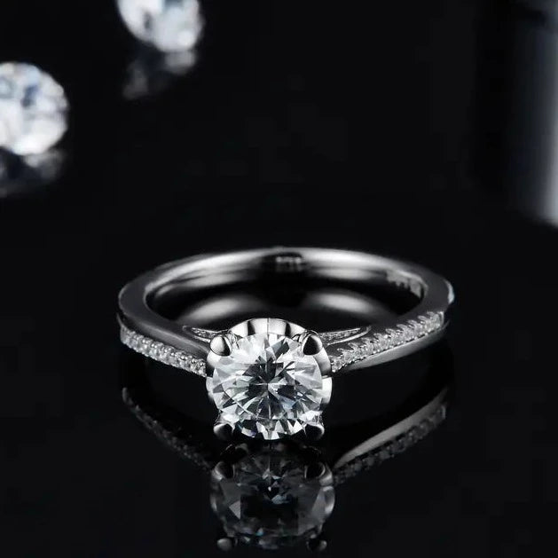 A sleek sterling silver engagement ring with a modern design, highlighting the sparkle of a 1.00ct moissanite.