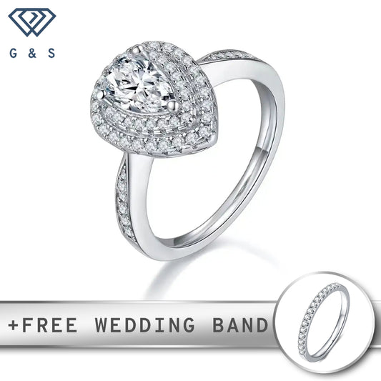 A 1.00ct pear-shaped moissanite center stone surrounded by two concentric halos of sparkling stones.