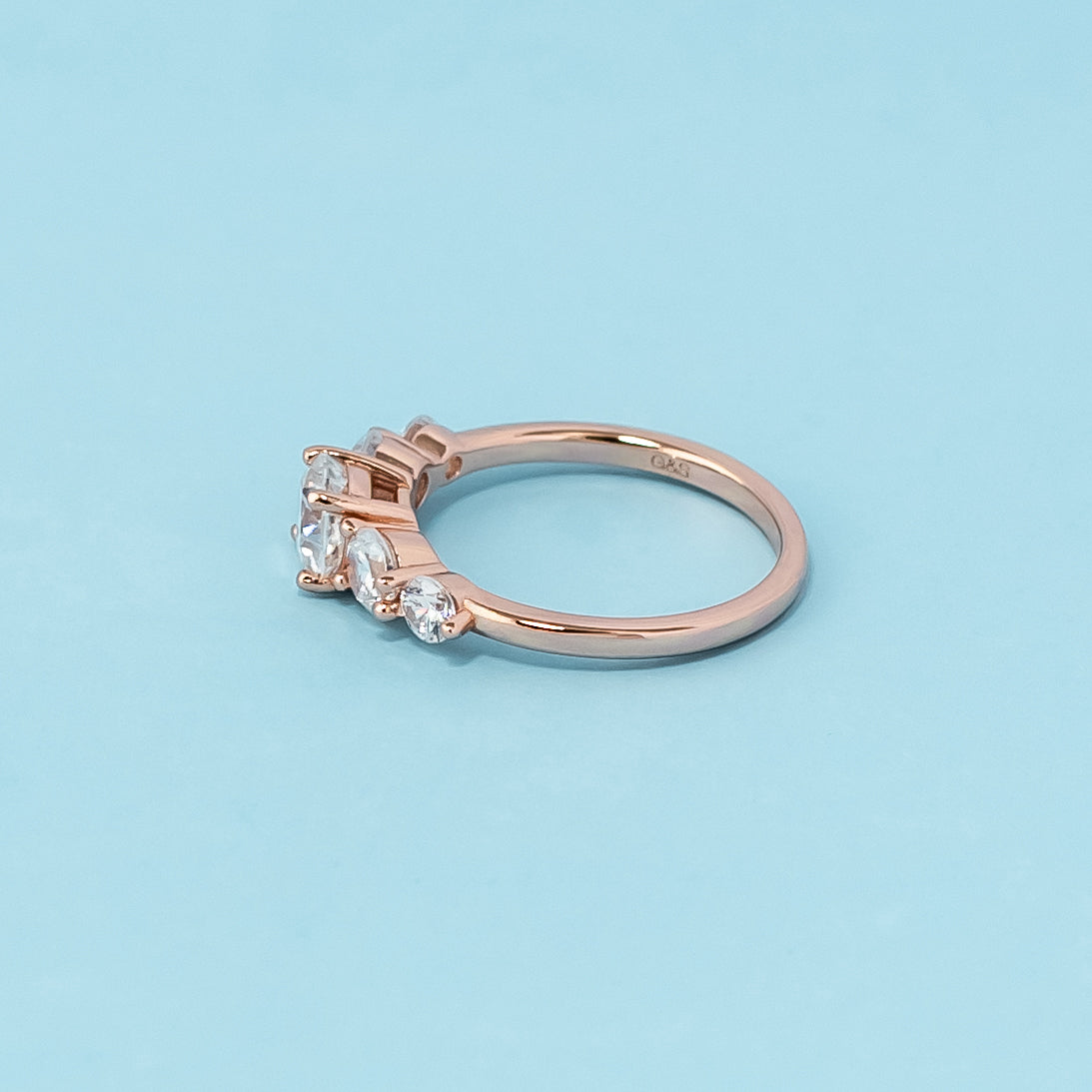 Elegant rose gold engagement ring showcasing five sparkling cushion cut moissanites in a classic design.