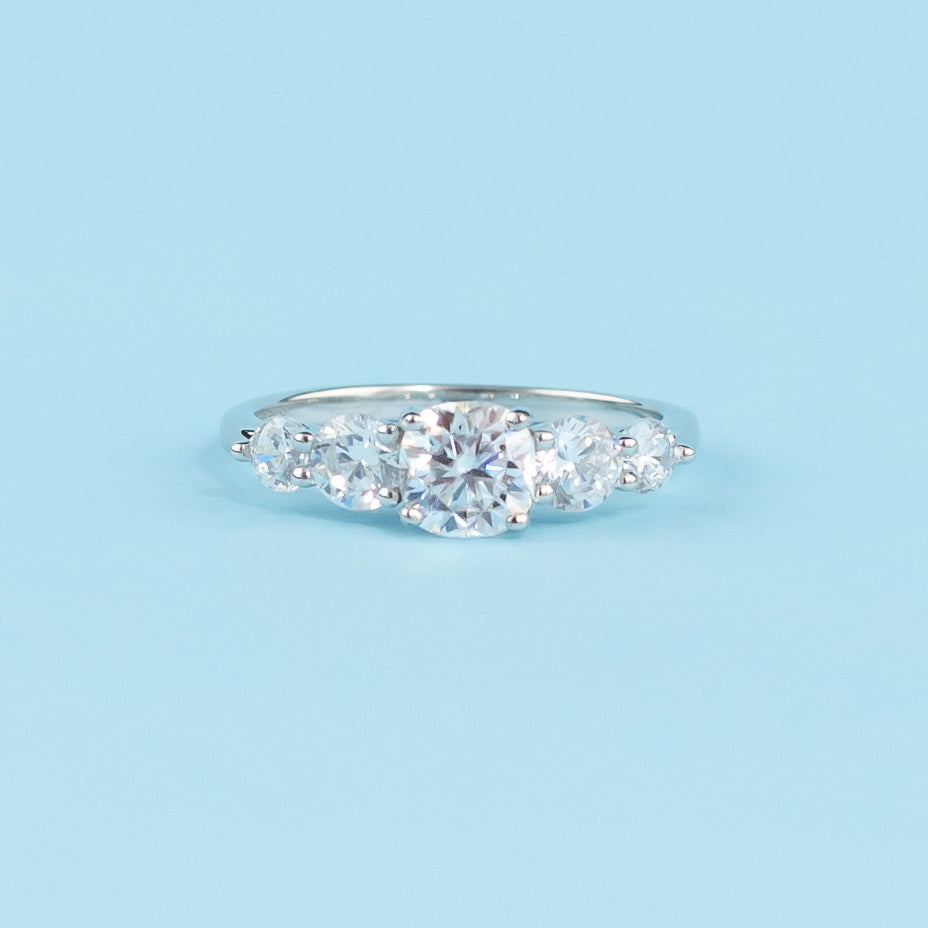 Elegant 9ct white gold engagement ring featuring five sparkling cushion cut moissanites.