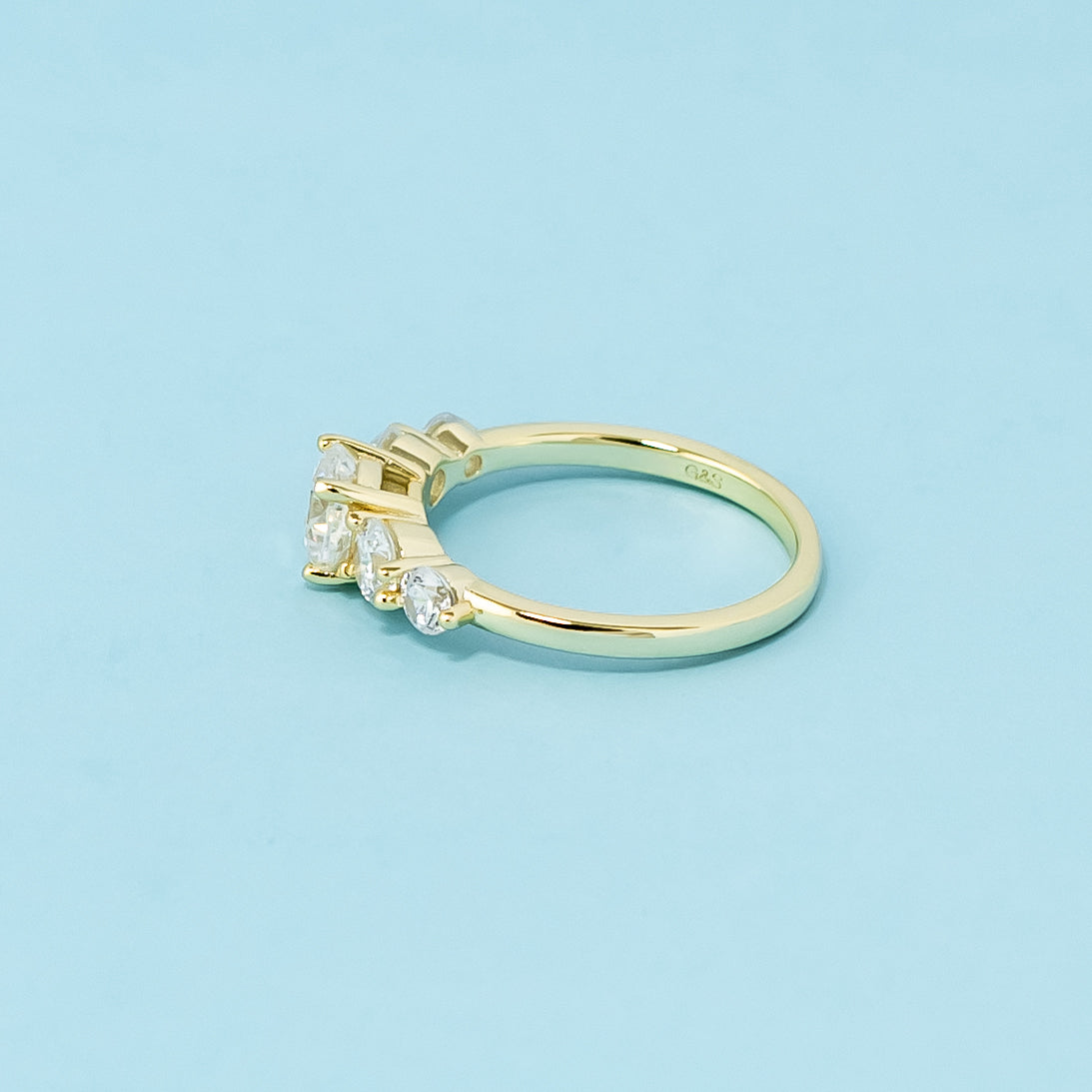 A stunning 9ct yellow gold ring with five dazzling cushion cut moissanites, perfect for symbolizing a lasting commitment.