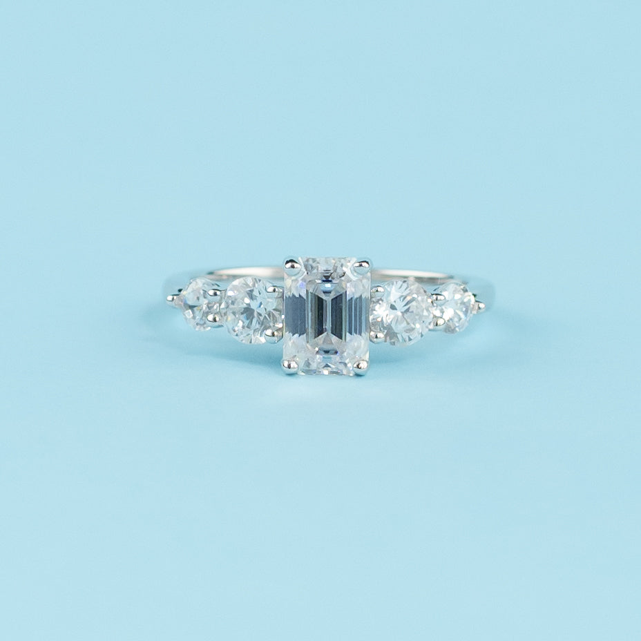 Elegant 9ct white gold engagement ring featuring five sparkling emerald cut moissanites in a classic setting.