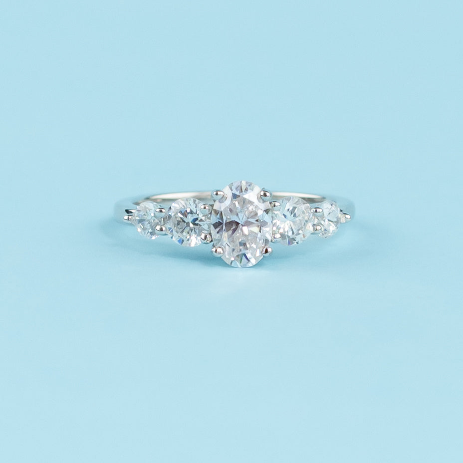 Elegant 9ct white gold engagement ring featuring five sparkling oval cut moissanites in a classic setting.