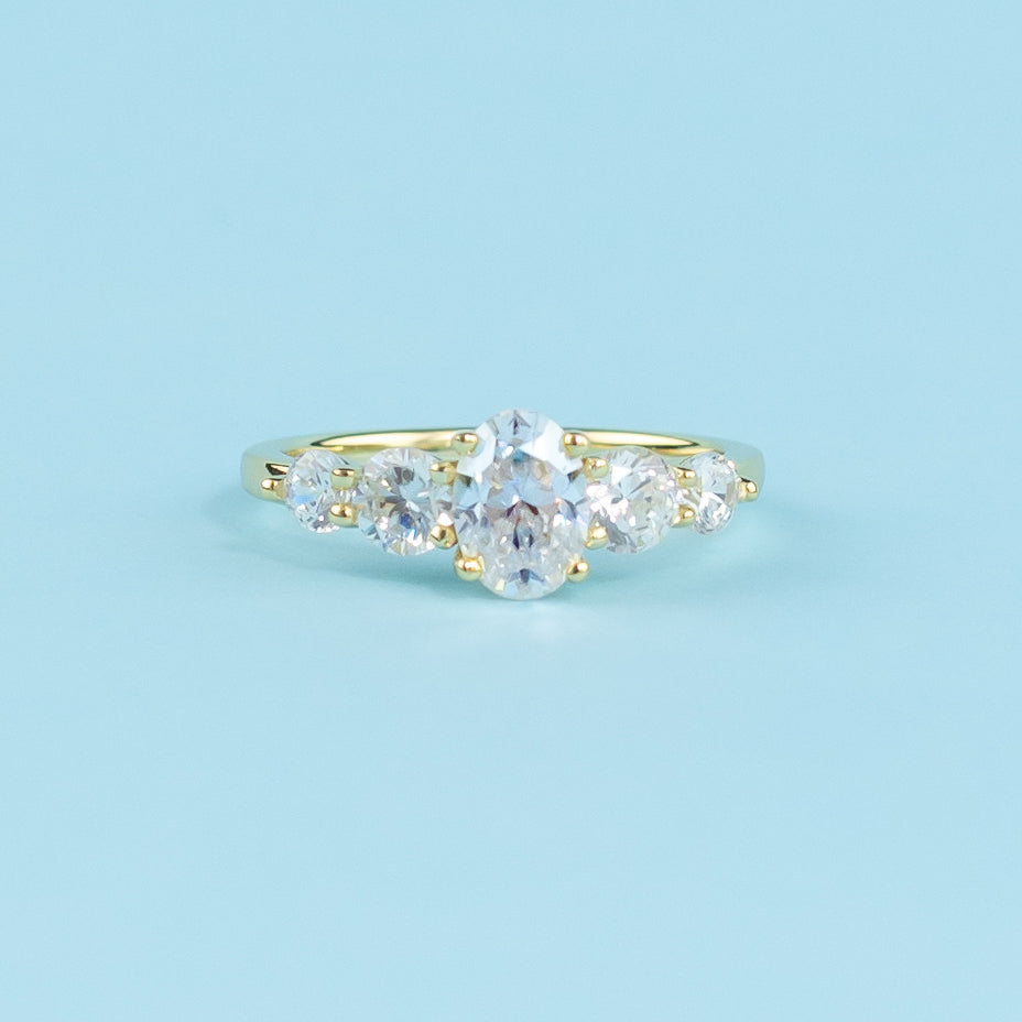 This elegant ring showcases five brilliant oval moissanites, representing a lifetime of shared moments.