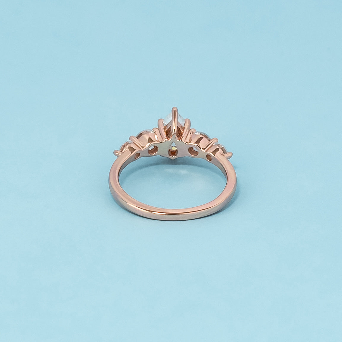 Luxurious 9ct rose gold engagement ring set with five beautiful pear-shaped moissanites, symbolizing enduring love and brilliance.