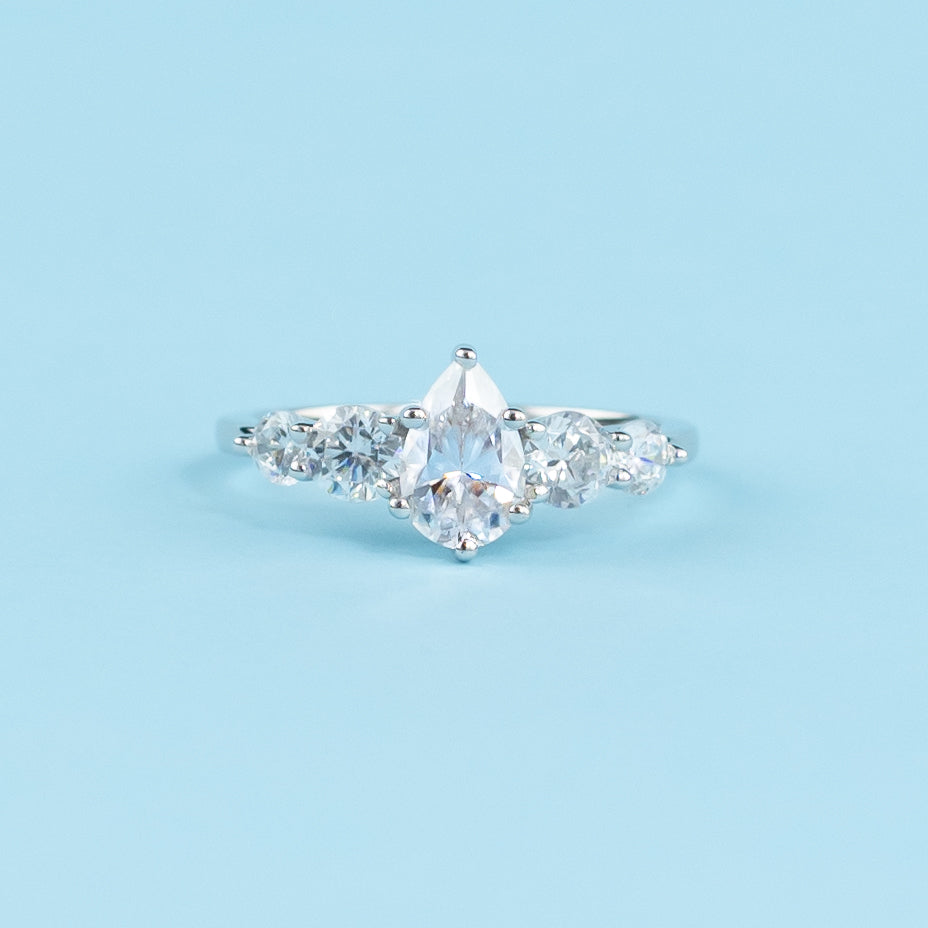 Elegant 9ct white gold engagement ring with five sparkling pear-shaped moissanites in a classic setting.