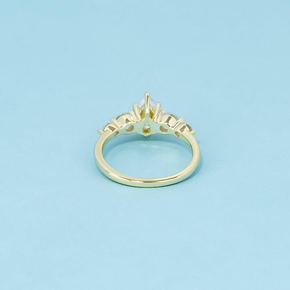 An elegant 9ct yellow gold engagement ring with five brilliant pear-shaped moissanites, perfect for a lasting commitment.