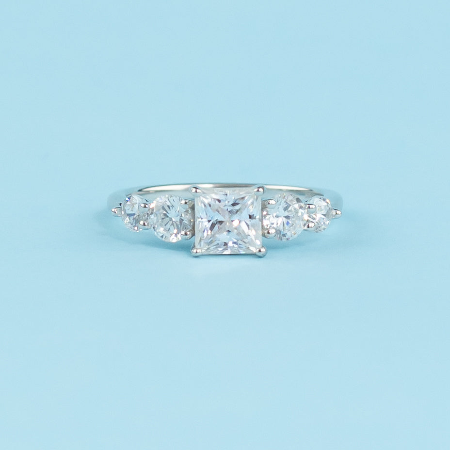 Elegant 9ct white gold engagement ring featuring five sparkling princess cut moissanites in a classic setting.