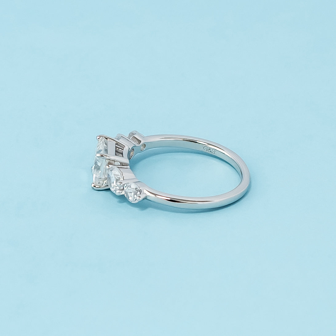 Stunning five-stone engagement ring showcasing the brilliance of princess cut moissanites, crafted in 9ct white gold.