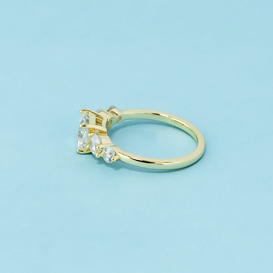 A stunning 9ct yellow gold ring with five sparkling princess cut moissanites, perfect for a lifetime of love.