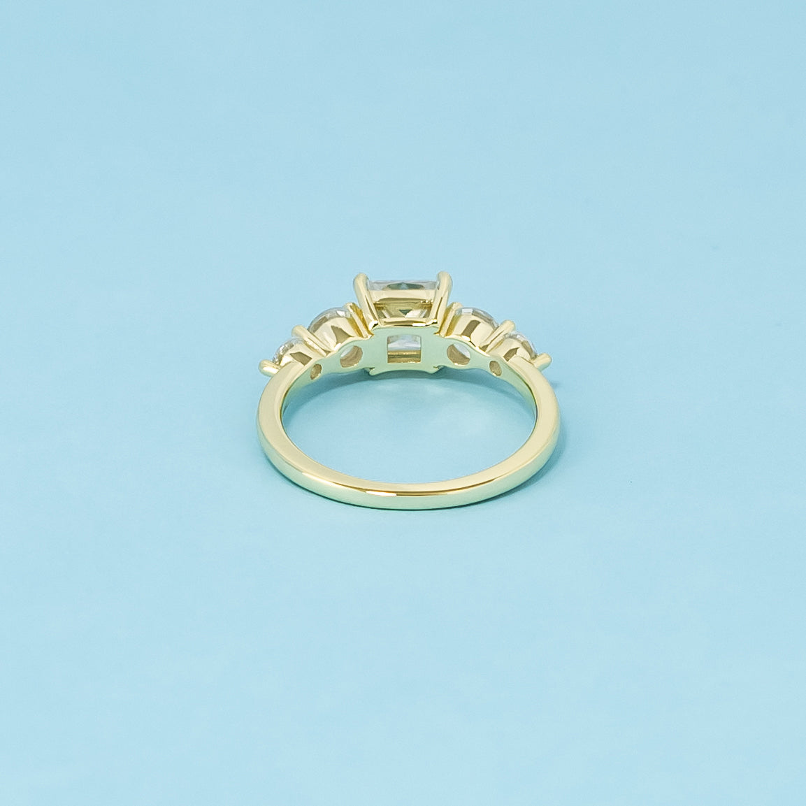 This 9ct yellow gold ring features five brilliant princess cut moissanites, symbolizing an everlasting bond.