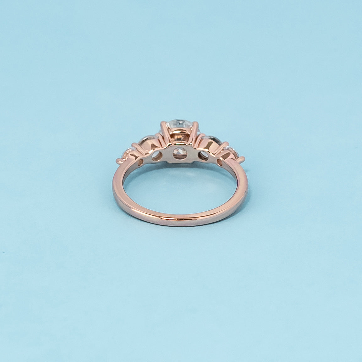 Luxurious 9ct rose gold engagement ring set with five beautiful round brilliant moissanites, symbolizing enduring love and brilliance.