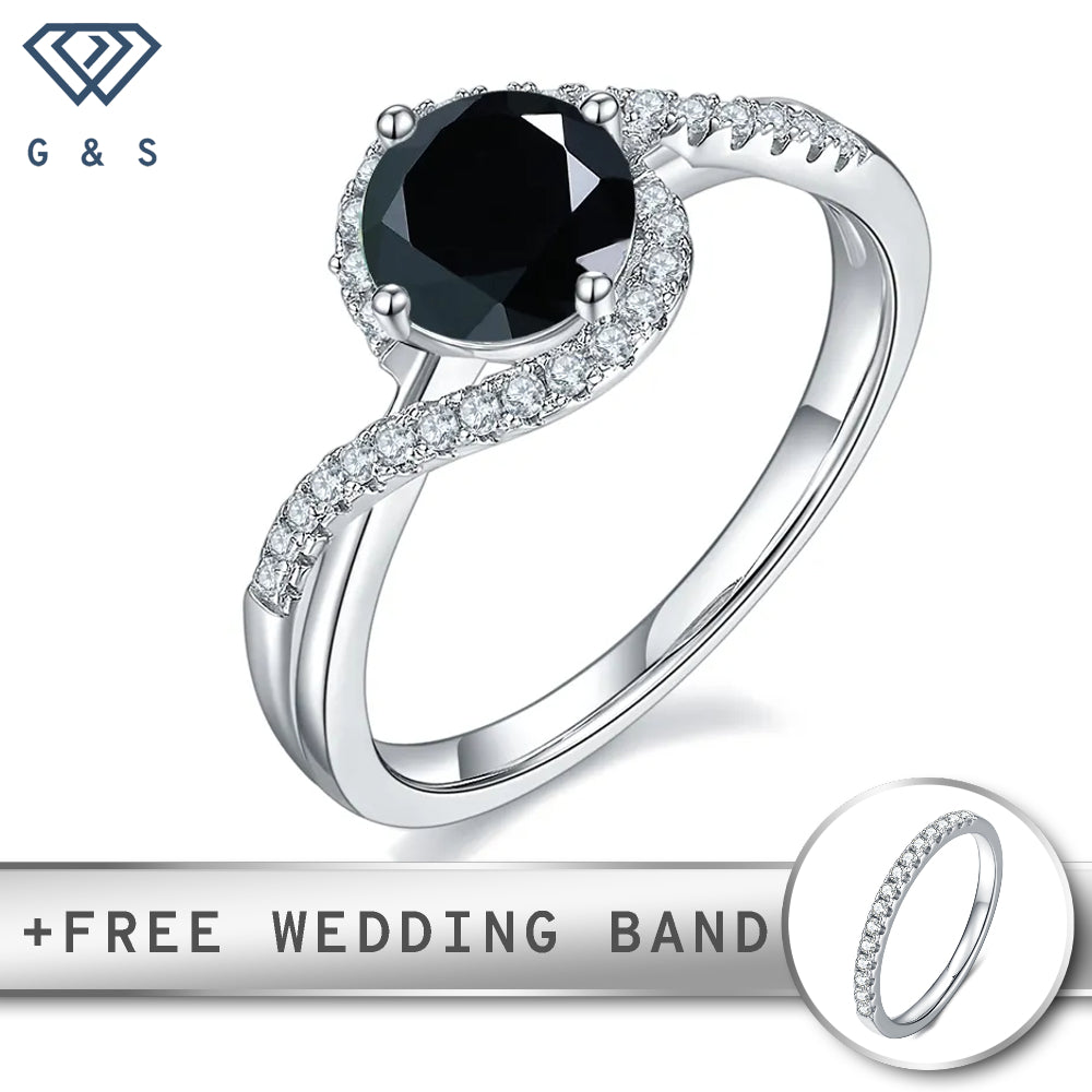A striking 1.00ct black moissanite takes center stage, encircled by a brilliant halo of smaller stones, all set in polished sterling silver.