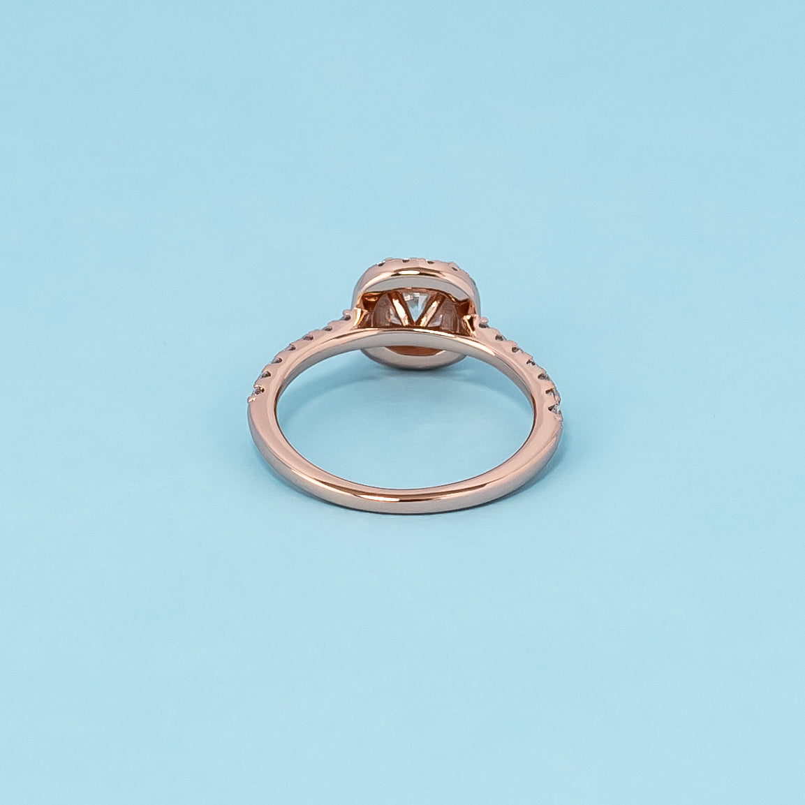 Timeless and luxurious 9ct rose gold engagement ring featuring a beautiful cushion cut moissanite in a classic halo design.