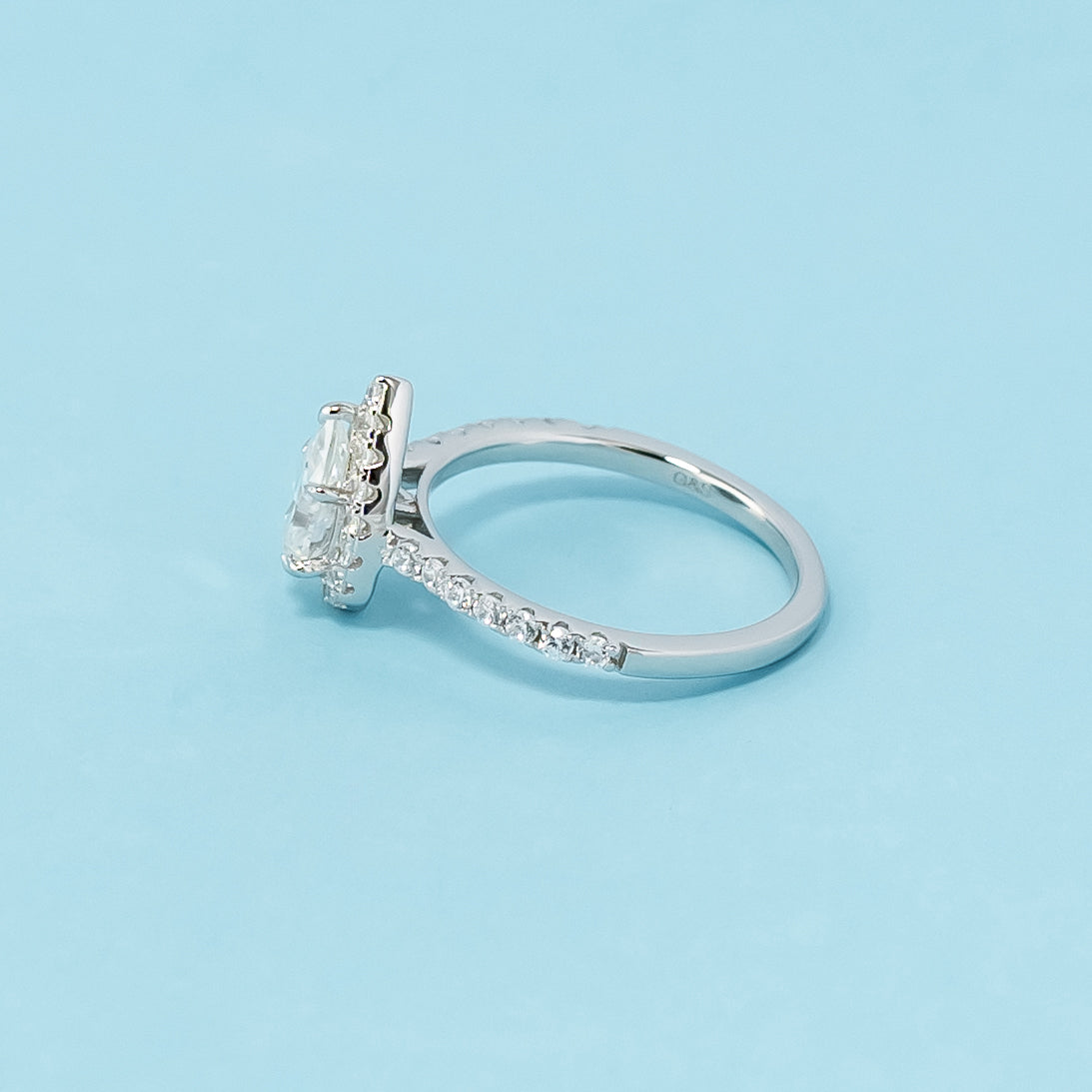 Timeless and sophisticated engagement ring showcasing a pear-shaped moissanite in a beautiful halo design, crafted in 9ct white gold.