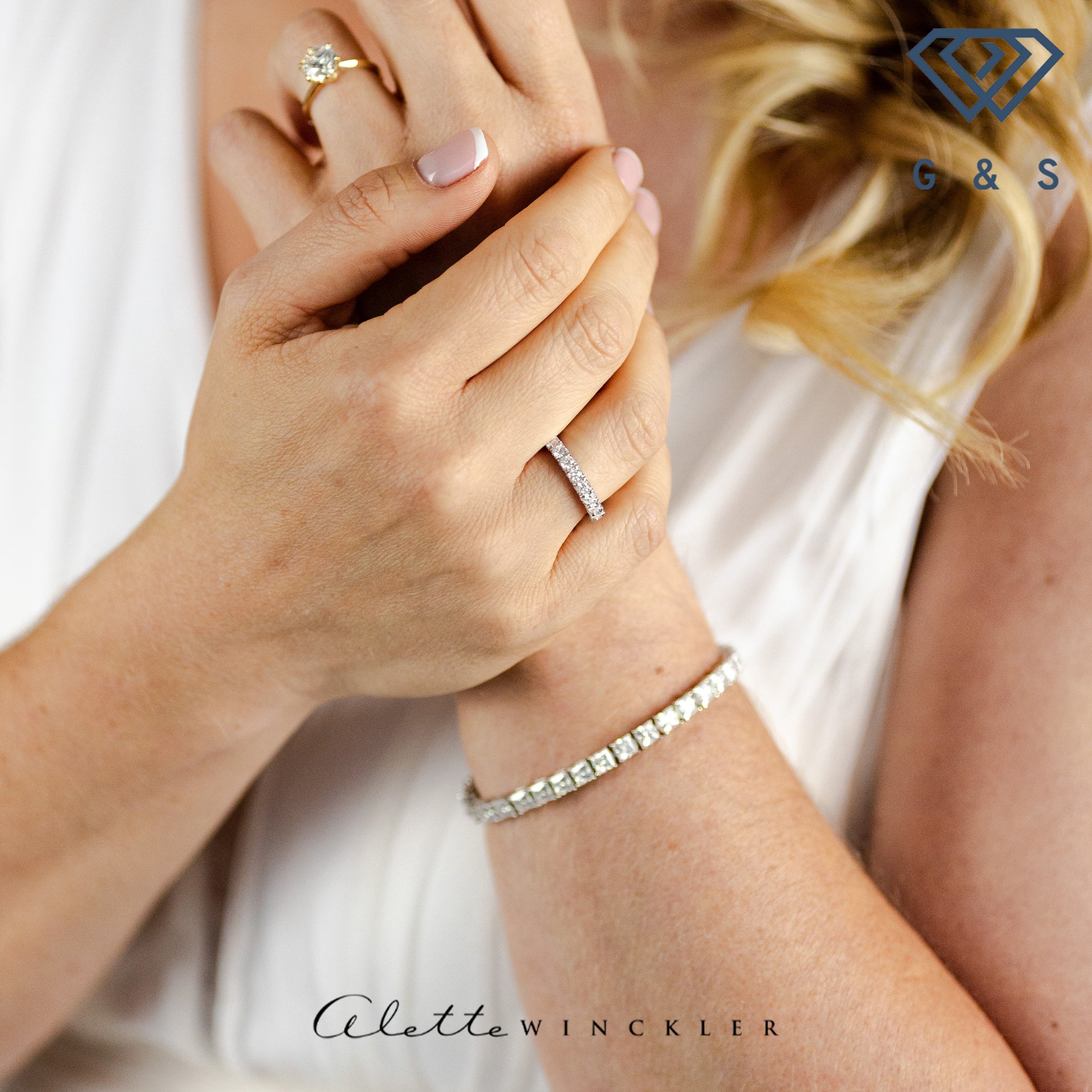 A ring with a continuous row of stones, designed for layering with other rings.