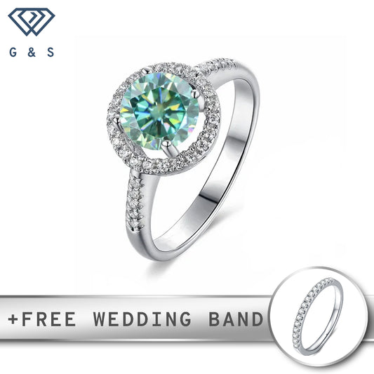A sterling silver engagement ring featuring a 1.00ct green moissanite center stone surrounded by a unique heart-shaped halo of smaller stones.