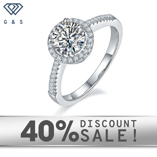 A 1.00ct moissanite sparkles within a delicate halo of hearts, set in 9ct white gold.