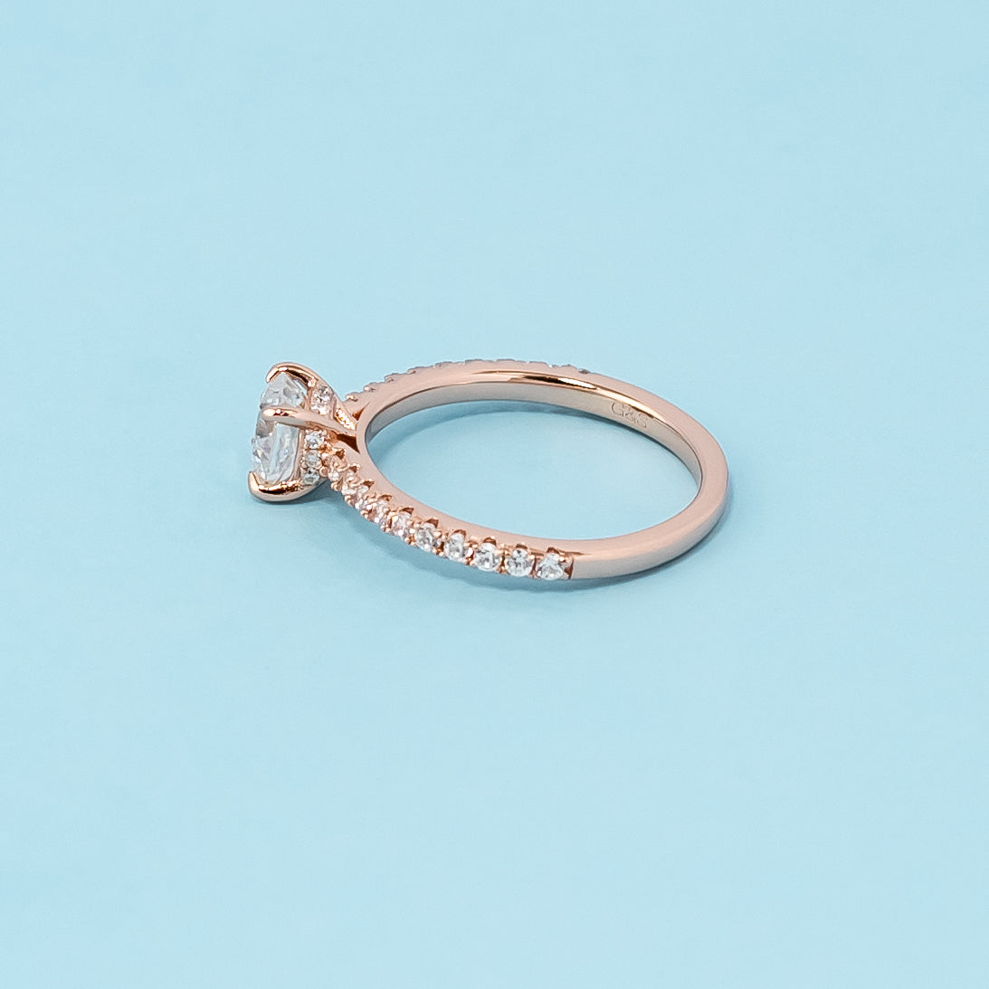Stunning rose gold engagement ring featuring a sparkling cushion cut moissanite and a unique hidden design.