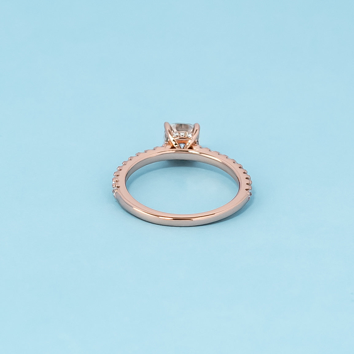 Luxurious 9ct rose gold engagement ring showcasing a beautiful cushion cut moissanite with a subtle hidden halo.
