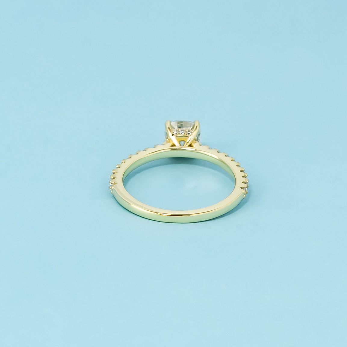 A sophisticated 9ct yellow gold engagement ring with a cushion cut moissanite and a hidden halo for extra elegance and shine.