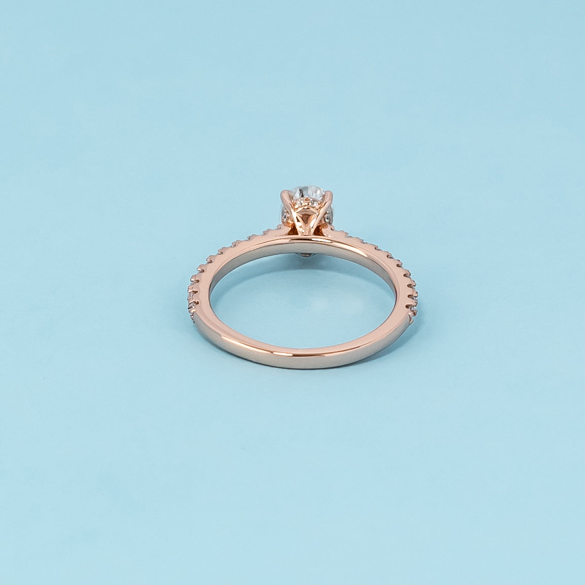 Luxurious 9ct rose gold engagement ring showcasing a beautiful oval cut moissanite with a subtle hidden halo.