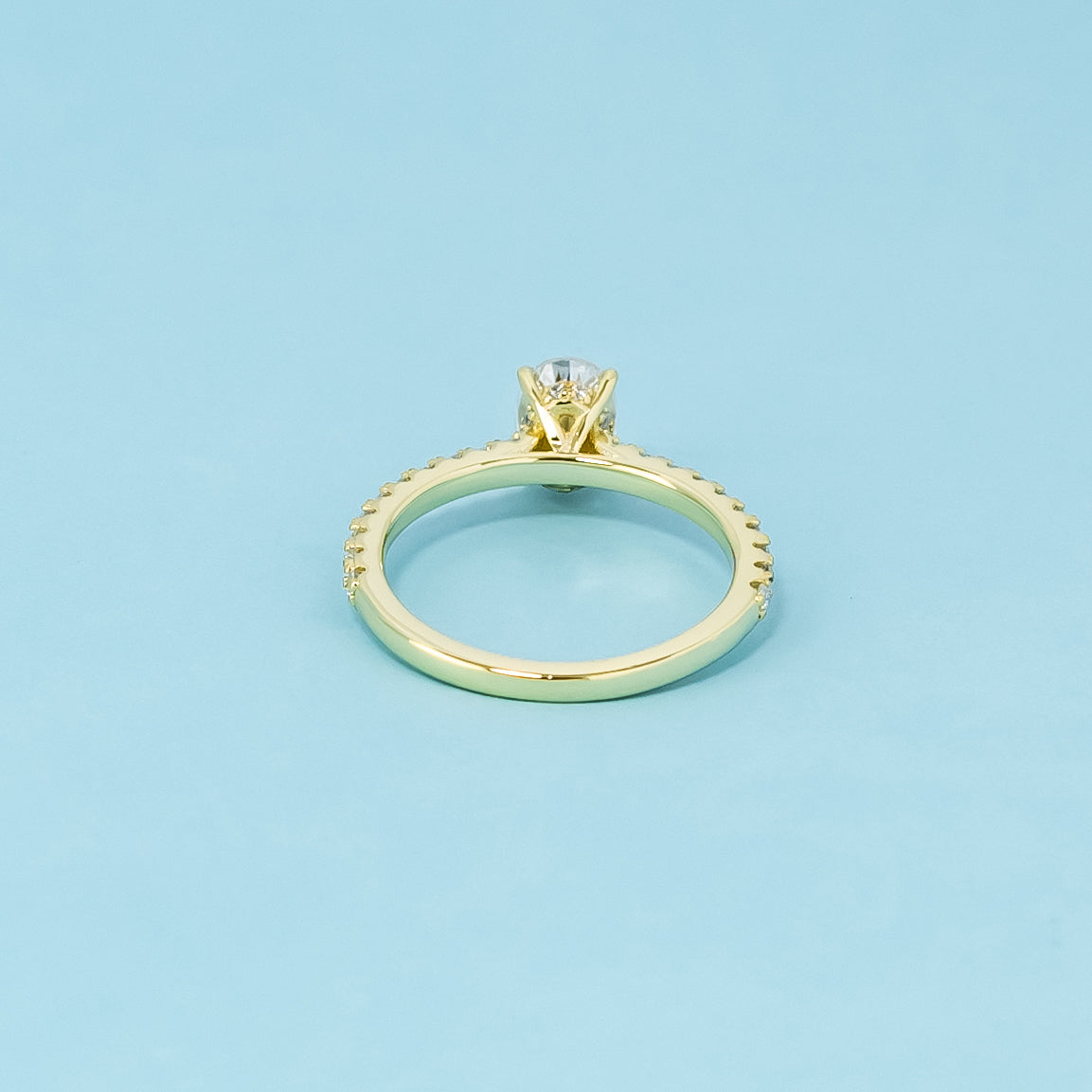 A sophisticated 9ct yellow gold engagement ring with an oval cut moissanite and a hidden halo for added elegance and shine.