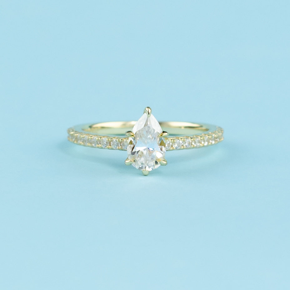 A beautiful pear-shaped moissanite engagement ring with a discreet hidden halo enhancing its brilliance.