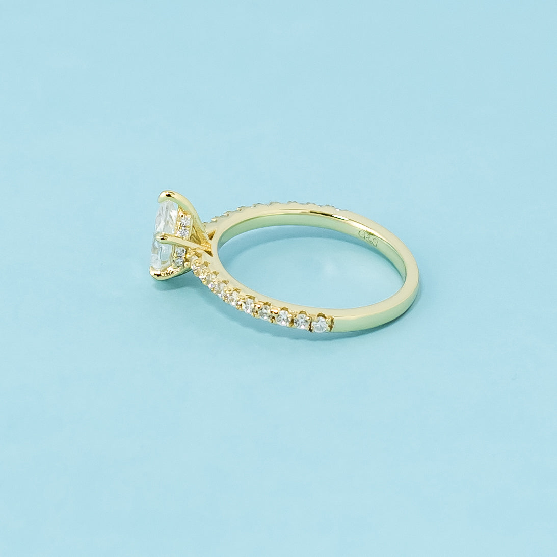 This 9ct yellow gold ring showcases a classic pear cut moissanite with a hidden halo detail.