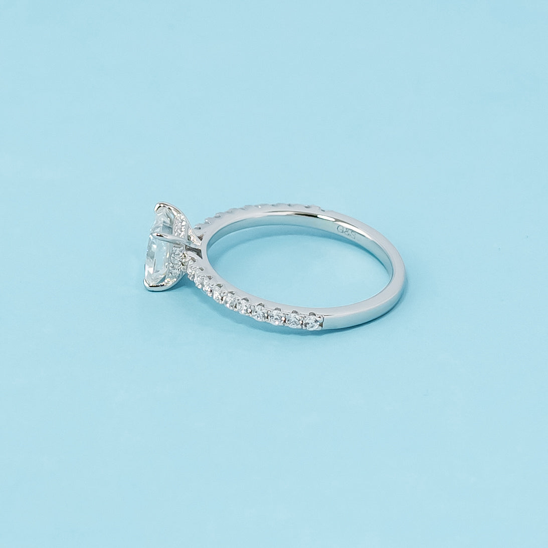 Modern and sophisticated engagement ring showcasing a princess cut moissanite in a unique hidden setting, crafted in 9ct white gold.