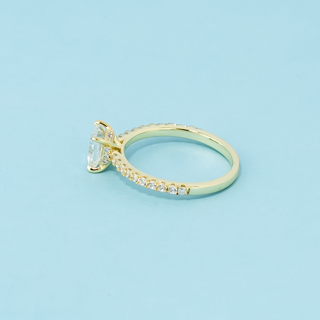 This 9ct yellow gold ring features a classic princess cut moissanite with a hidden halo detail.