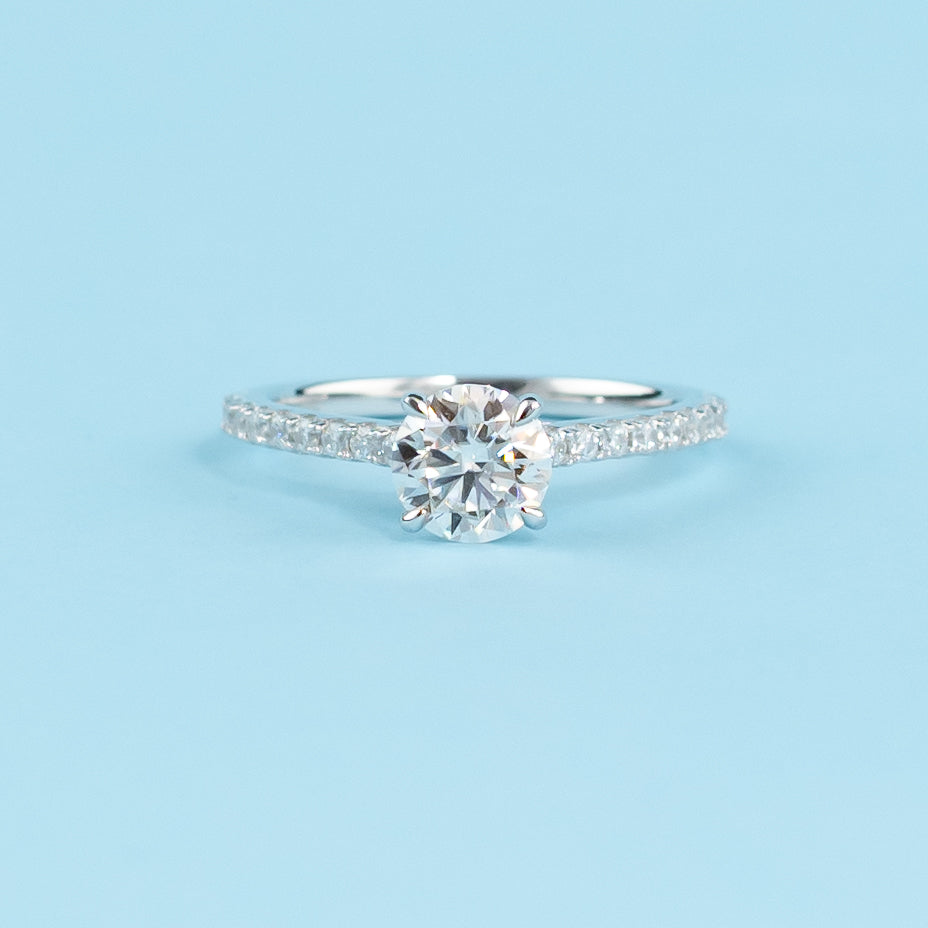 Elegant 9ct white gold engagement ring featuring a hidden setting that maximizes the sparkle of the round brilliant moissanite.