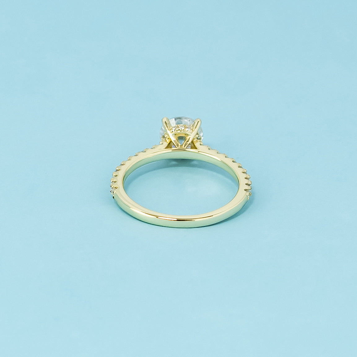  A sophisticated 9ct yellow gold engagement ring with a round brilliant moissanite and a hidden halo for added elegance and shine.