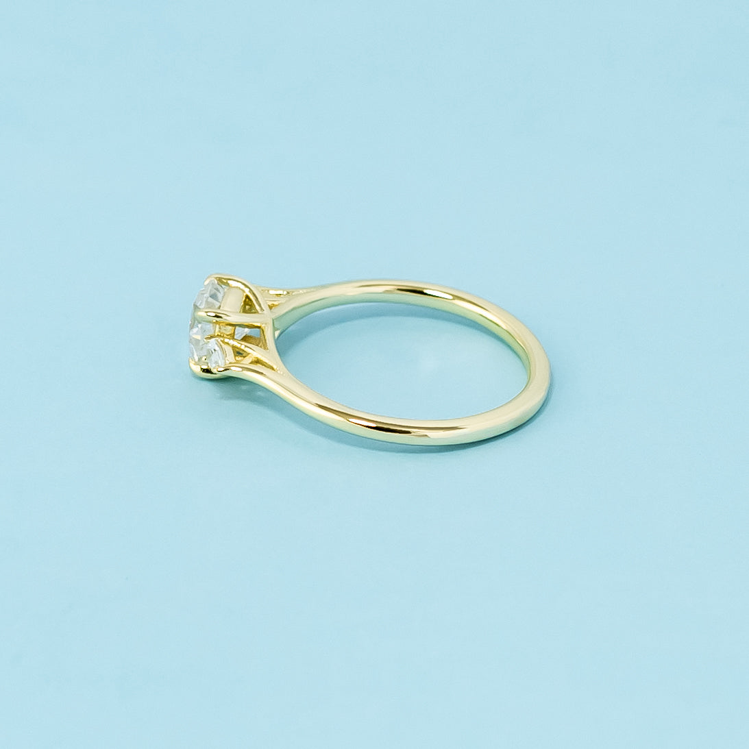 This 9ct yellow gold ring features three beautifully cut cushion moissanites in a classic trilogy design.