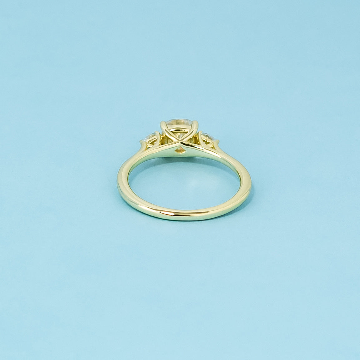 This elegant 9ct yellow gold engagement ring displays three brilliant cushion cut moissanites, perfect for symbolizing a lasting commitment.