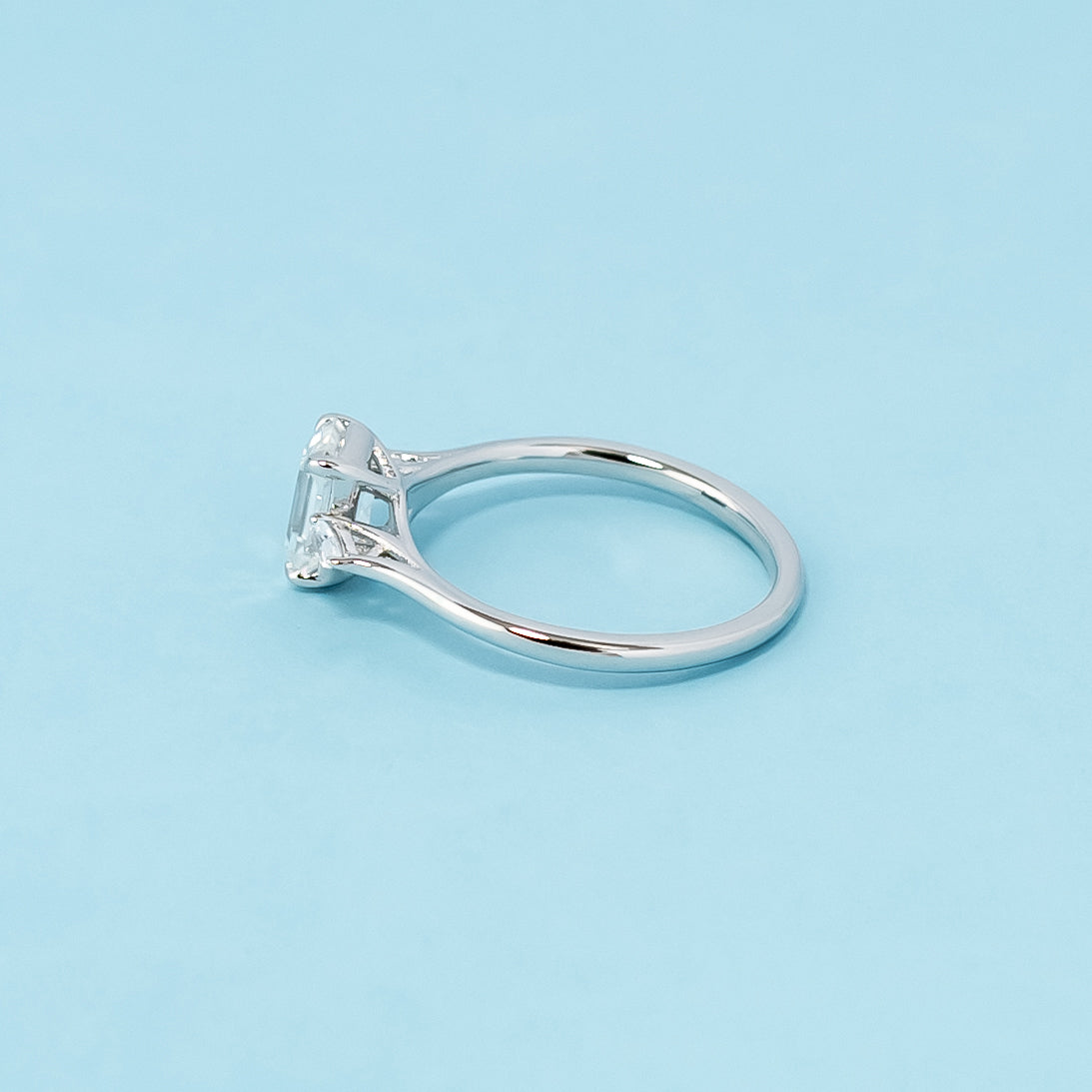 Modern and symbolic engagement ring showcasing emerald cut moissanites representing past, present, and future love, set in 9ct white gold.