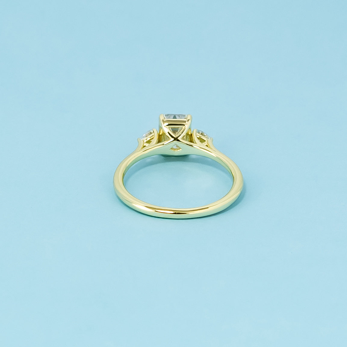 A beautiful trilogy design with three stunning emerald cut moissanites, representing infinite love.