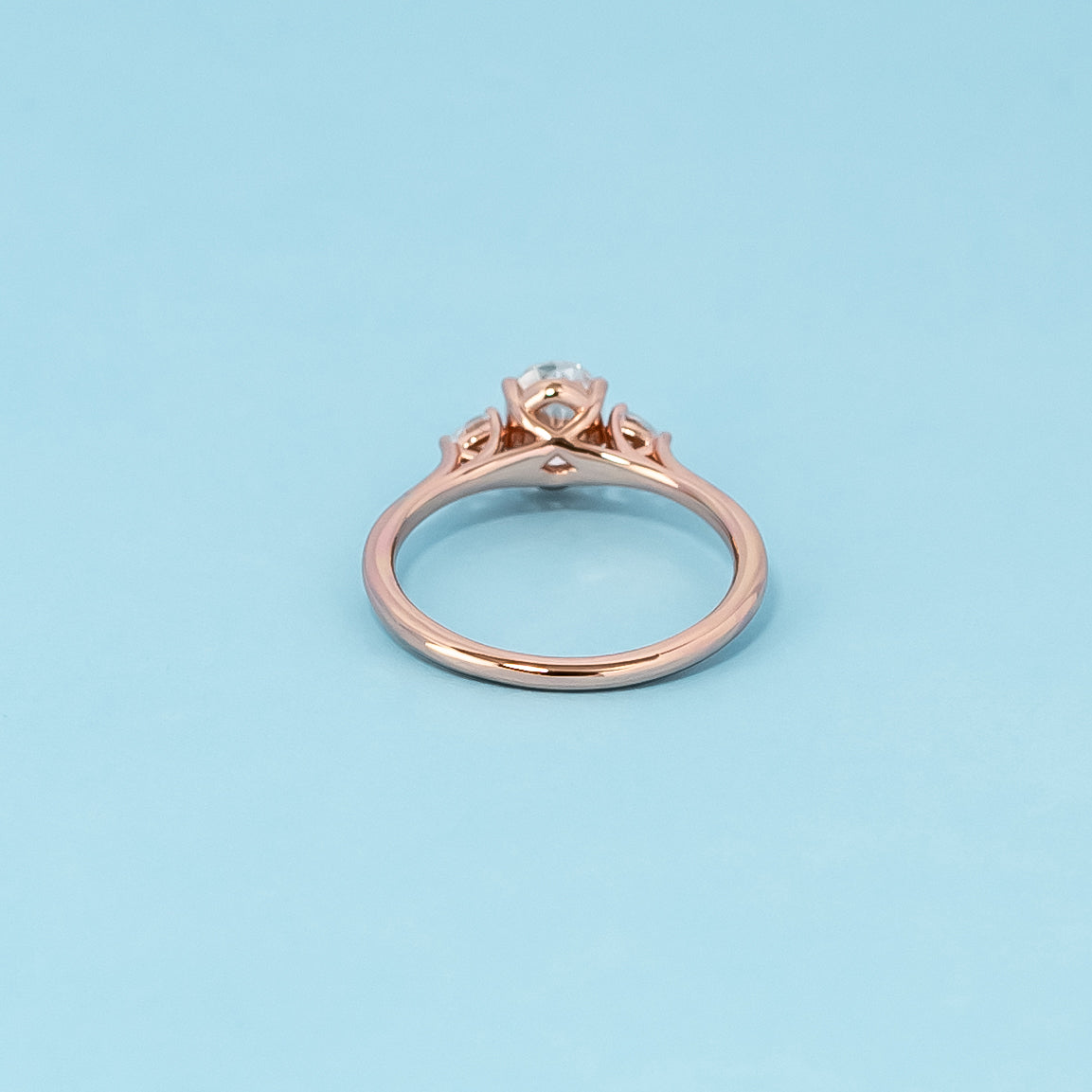 Luxurious 9ct rose gold engagement ring set featuring three beautiful oval cut moissanites, representing enduring love.